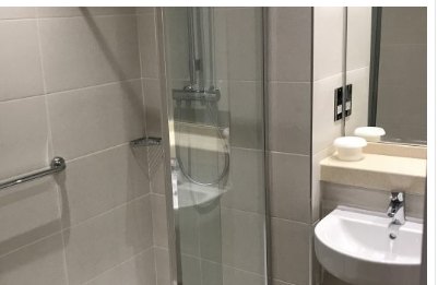 Refurbished hotel shower room with glass screen