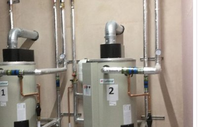 Twin commercial water heaters with copper and insulated pipework